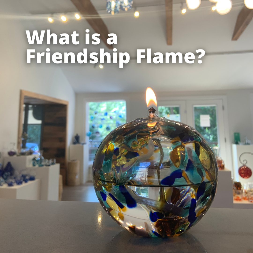 An Iris Fire Friendship Flame, handblown glass oil lamp. Text reads "What is a Friendship Flame?"