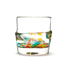 Load image into Gallery viewer, Hand blown glass whiskey glass, clear with a swirl of yellow, red, orange, and green glass on the bottom. Colour combination is called &quot;Autumn.&quot;