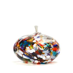 Handmade squat multicoloured rainbow glass oil lamp. Made in Ontario Canada by Gray Art Glass.