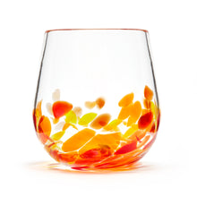 Load image into Gallery viewer, Hand blown glass wine glass. Clear glass with a swirl of red, yellow, and orange glass on the bottom. Colour combination is called &quot;Sunburst.&quot;