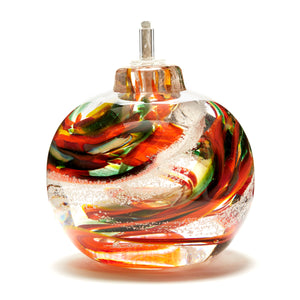 Round memorial glass art eternal flame oil lamp with cremation ash. Yellow, red, orange, and green glass. Colour combination is called "Autumn."
