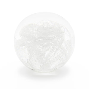 Round memorial glass art paperweight with cremation ash. Clear glass.