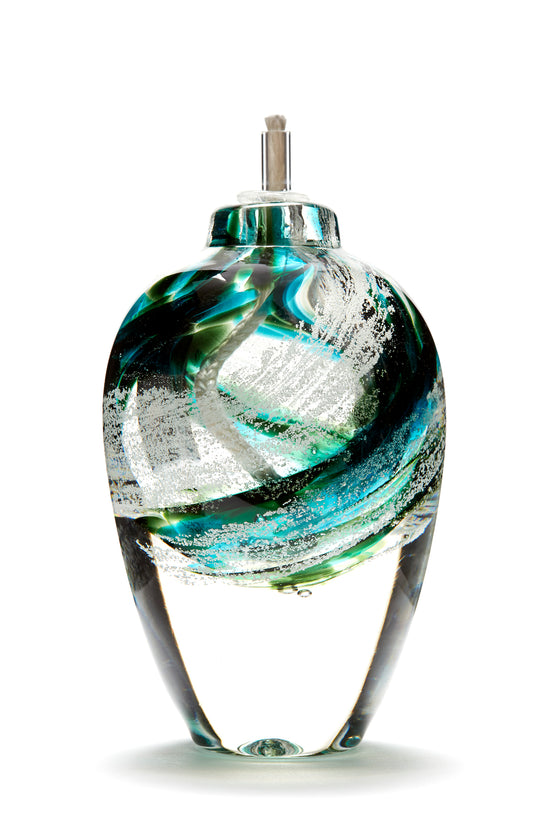 Memorial glass art tall eternal flame oil lamp with cremation ash. Green glass. Colour combination is called “Emerald.”