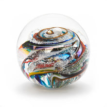 Load image into Gallery viewer, Round memorial glass art paperweight with cremation ash. Purple, blue, yellow, red, orange, green, and white glass. Colour combination is called &quot;Multi.&quot;