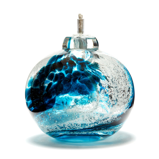 Load image into Gallery viewer, Round memorial glass art eternal flame oil lamp with cremation ash. Teal blue glass. Colour combination is called &amp;quot;Ocean Wave.&amp;quot;
