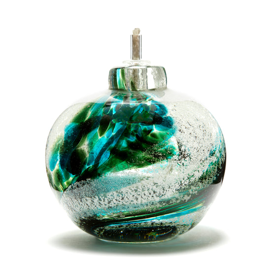 Round memorial glass art eternal flame oil lamp with cremation ash. Green glass. Colour combination is called “Emerald.”