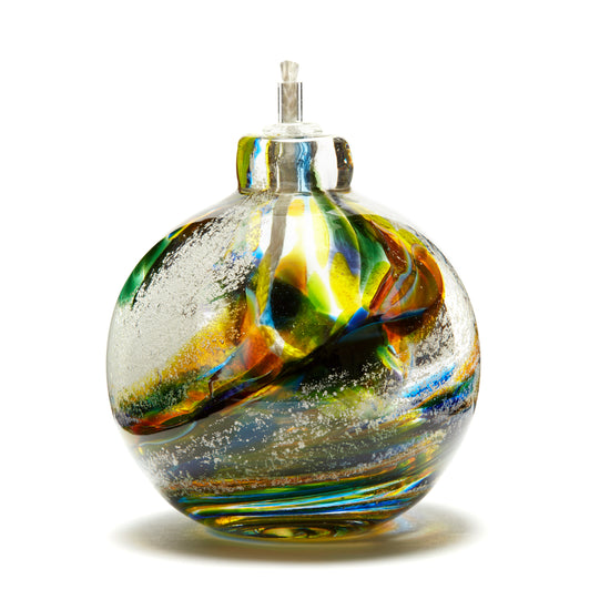 Load image into Gallery viewer, Round memorial glass art eternal flame oil lamp with cremation ash. Purple, blue, green, pink, and yellow glass. Colour combination is called &amp;quot;Spring.&amp;quot;
