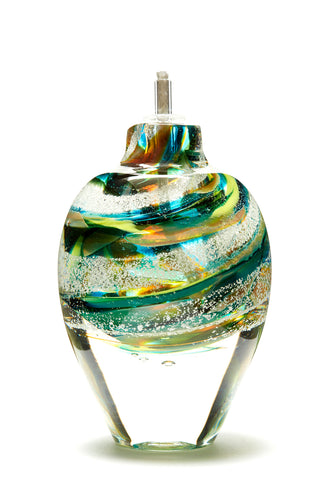 Memorial glass art tall eternal flame oil lamp with cremation ash. Teal blue, yellow, and green glass. Colour combination is called 