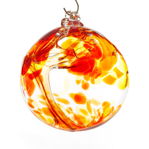 Hand blown glass witch ball. Red, yellow, and orange glass. Colour combination is called "Sunburst."